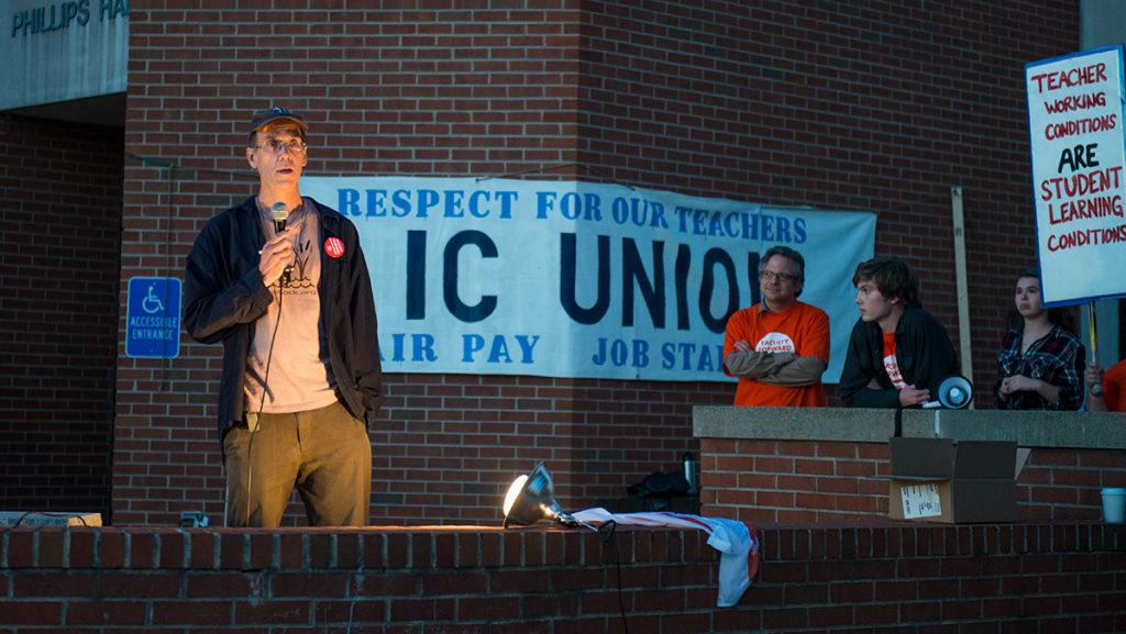 Ithaca College lecturer John Burger speaks at a rally in support of the contingent faculty  union Oct. 19 at the Free Speech Rock. The rally was organized by IC Students for Labor Action. 