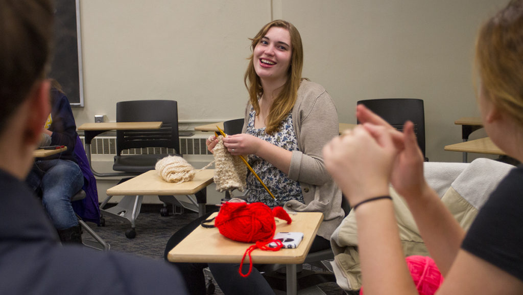 Senior Sabina Leybold is very active in the Ithaca College community as a volunteer. Above, she is pictured knitting garments to send to hospital patients through IC Project Sunshine.