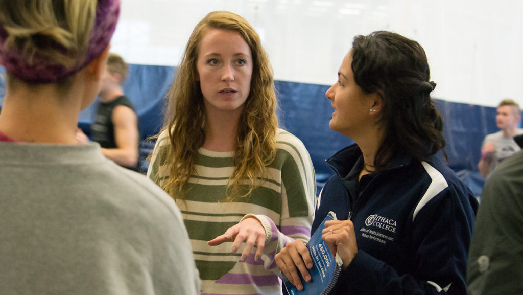 Second-year graduate students Meghan Cass and Alexa Rick coach at the Ithaca College womens cross-country practice Oct. 29 in the Athletics and Events Center. 