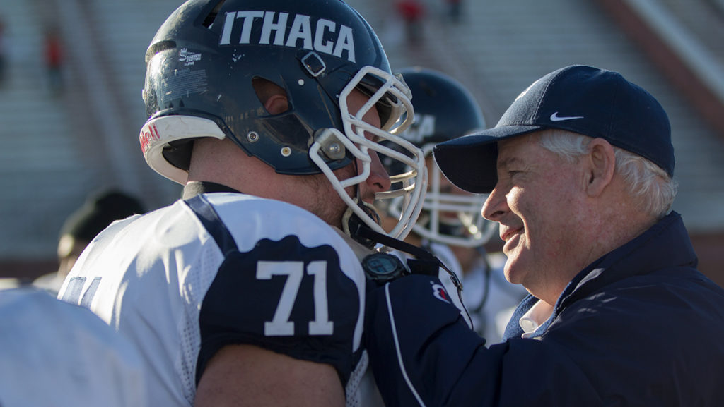 Ithaca College football head coach Mike Welch hugs senior offensive lineman Jack Meehan after the game. This was the last game of Welchs career. 