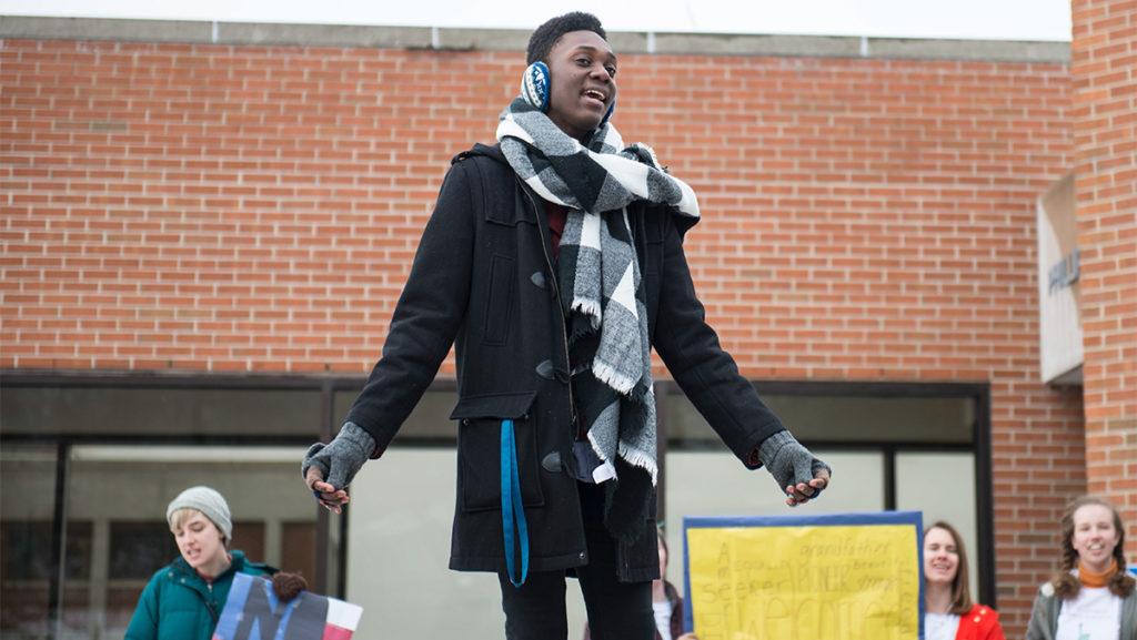 Freshman Mac-Andrew Nelson led the crowd in a chorus of “We Shall Overcome” on Feb. 10 at Free Speech Rock, for a rally against President Donald Trump’s immigration ban.