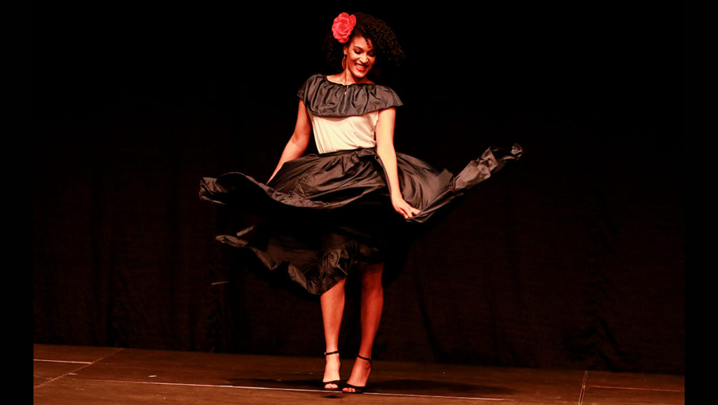 Freshman Michele Paniagua twirls in her dual-toned dress and heels from the Dominican Republic.