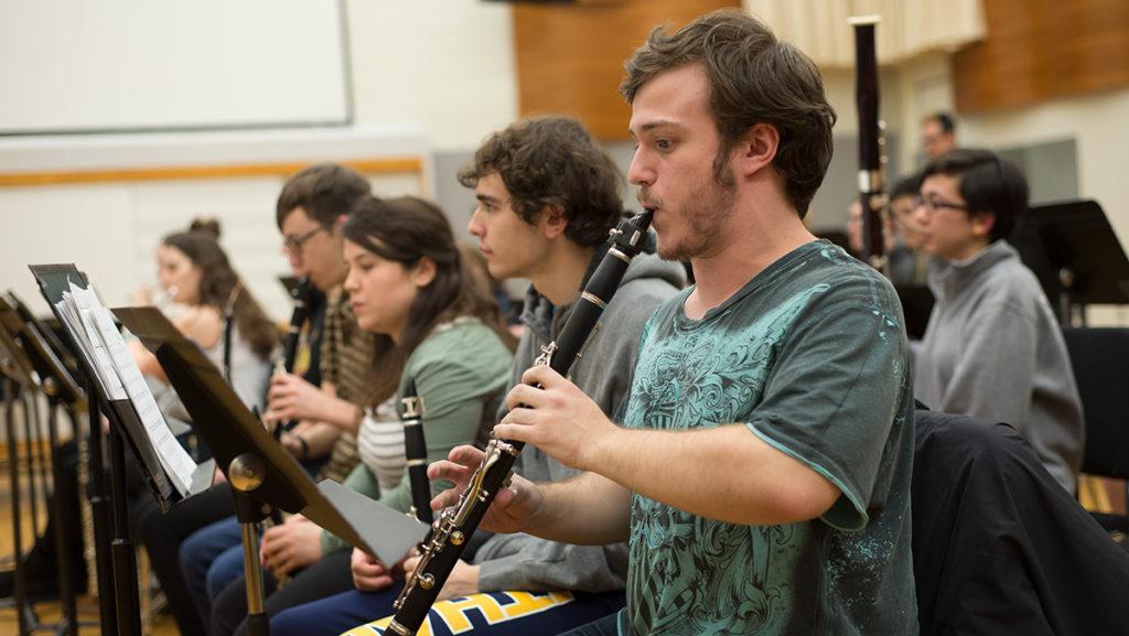Sophomore Griffin Charyn, clarinetist, plays along to “Cara Mia Addio” from “Portal 2,” conducted by Bryce Tempest at the Feb. 12 rehearsal. Through music, the group aims to be empowered by the nerd stereotype that’s often associated with video gamers.