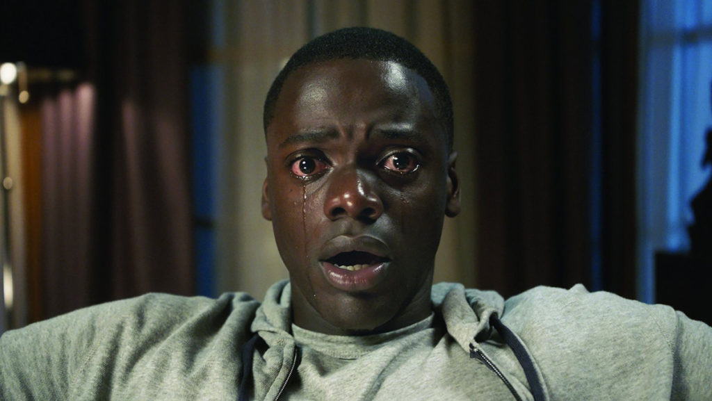 Get Out follows Chris (Daniel Kaluuya), a black photographer, as he visits his white girlfriends parents. What begins as an awkward, first meeting quickly turns sinister as the neighborhoods twisted secrets come to light. 
