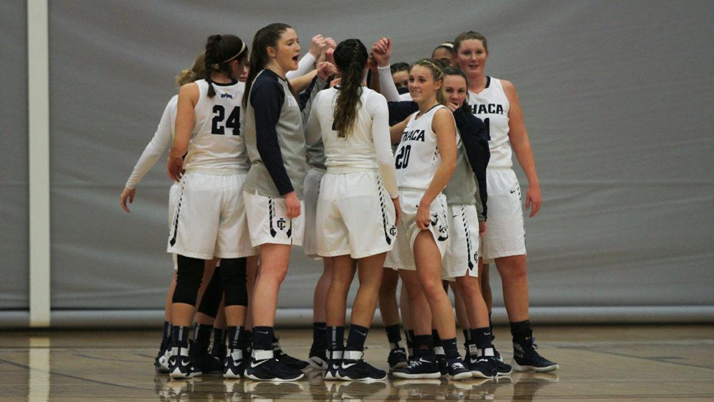 The womens basketball team huddle together before their game against Utica College Jan. 26. The Bombers won 70-56.