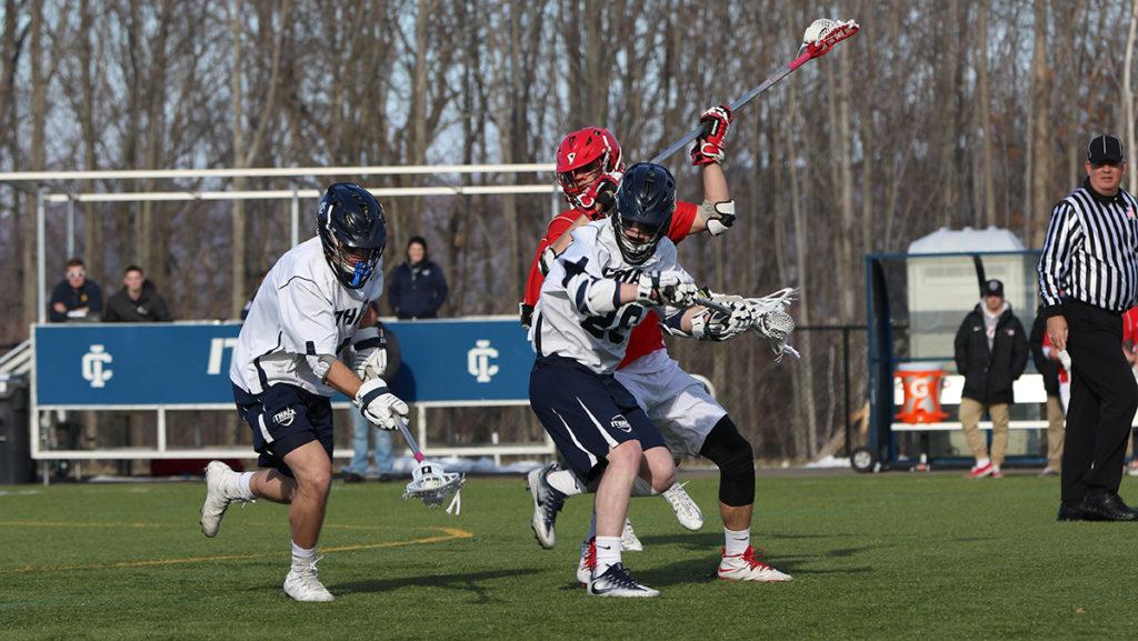 Defenseman senior Austin Smith picks up a ground ball in the Bombers 12–6 win over SUNY Oneonta March 21 at Higgins Stadium. Smith had three ground balls on the day.