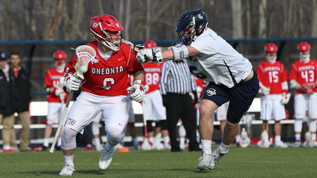 Sophomore midfielder Josh Della Puca blocks SUNY Oneonta junior midfielder TJ Kilmetis in the Bombers' 12–6 win on March 21. Della Puca had two goals and three ground balls.