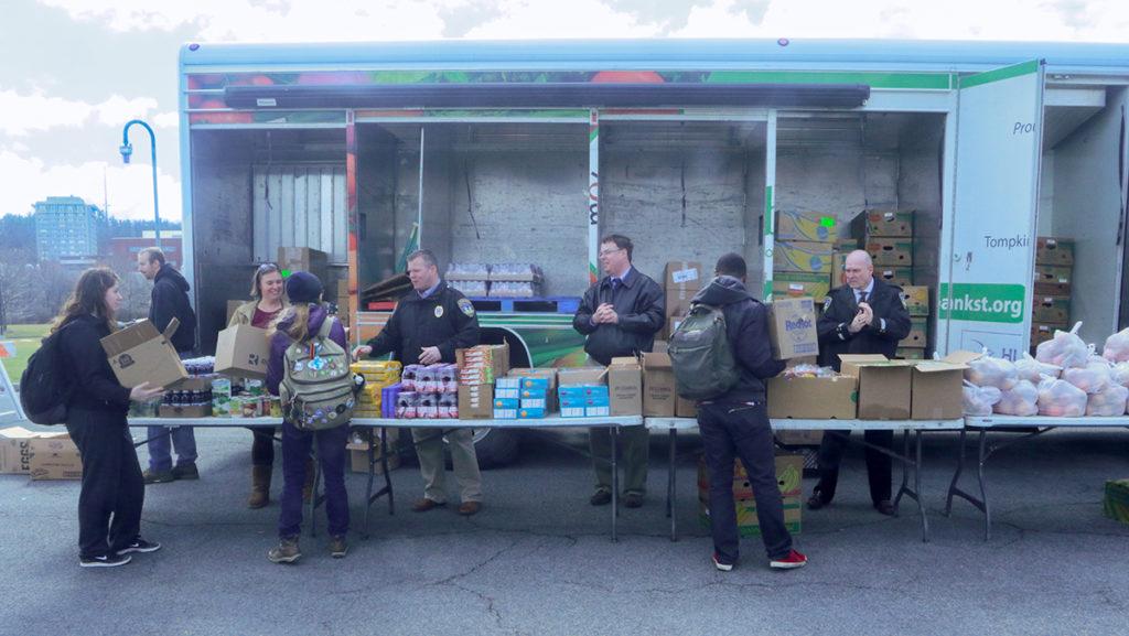 Students collecting food from the Mobile Food Pantry being distributed by members of Public Safety and other volunteers on March 29. The pantry will also be at the college during the noon hour April 7 and May 3.
