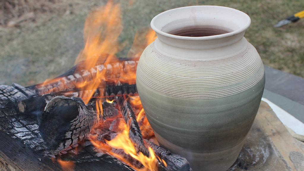 To imitate life in the Middle Ages, Scott Stull, assistant professor in the Department  of Anthropology, cooks short ribs in a medieval fashion by leaving a clay pot near a fire.
