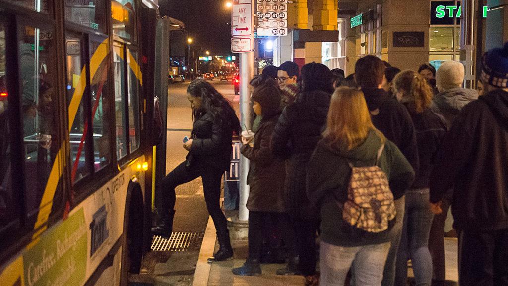 Bus passengers board the TCAT headed up to Ithaca College from The Commons. Rowdy student behavior has been observed at the Towers pickup location where Ithaca College has had to employ safety measures. 