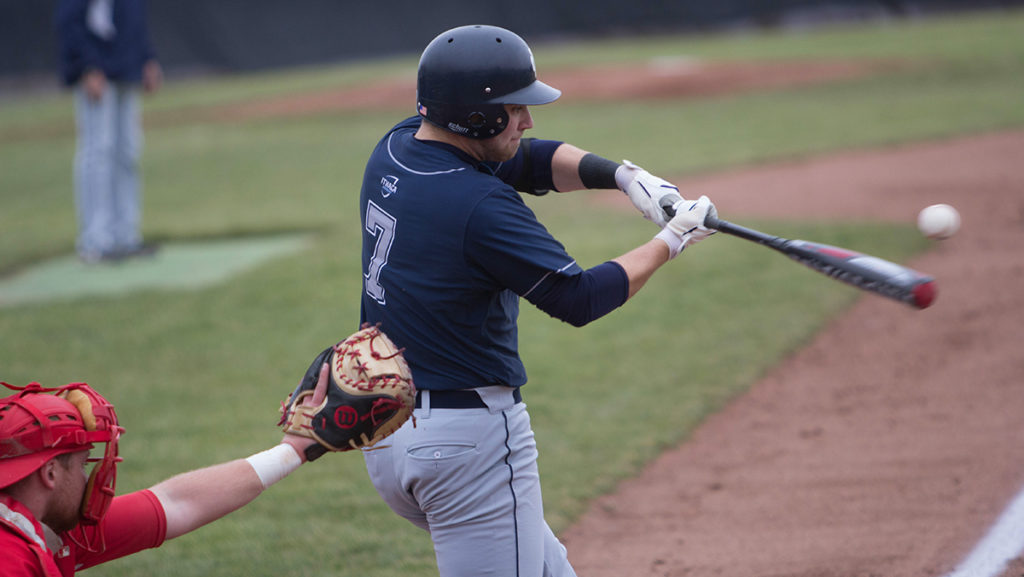 Senior Trevor Thompson at the contact point in his swing during the Bombers home game against SUNY Oneonta. The team travels to Elmira, New York to play Elmira College in a triple header April 8 and April 9.