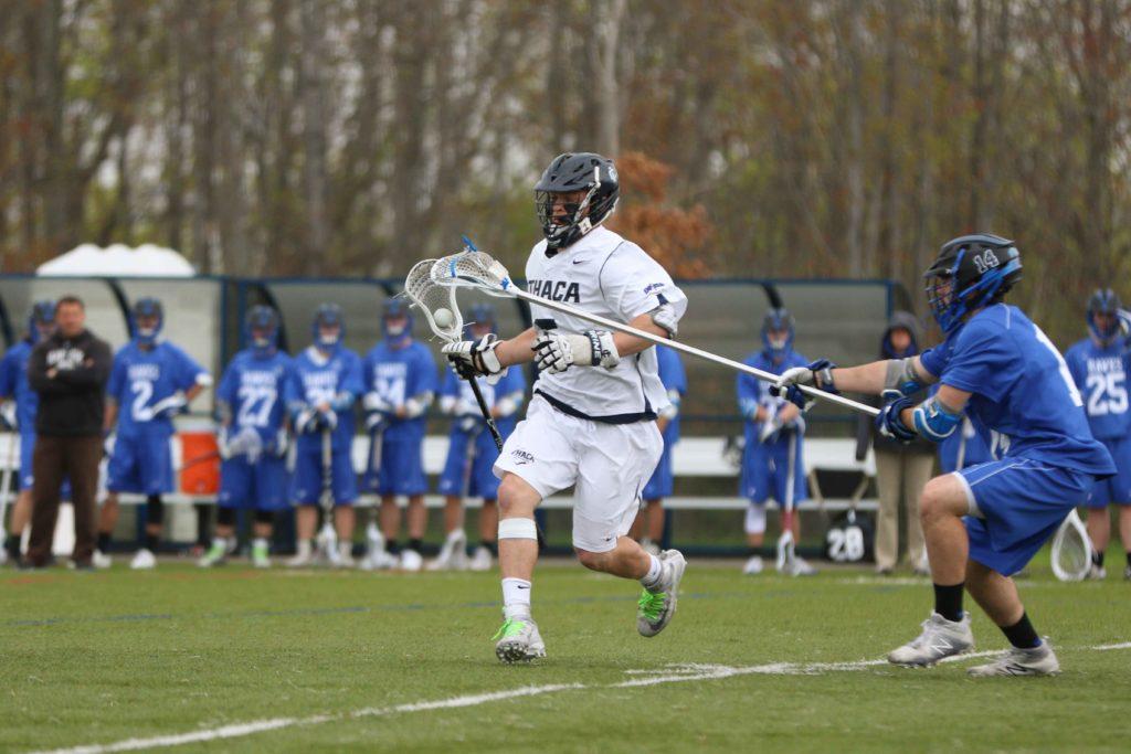 Sophomore midfielder Josh Della Puca has the ball and looking to pass to a teammate while sophomore defender Matthew Puzo of Hartwick looked to hit Della Puca to get the ball back. The Bombers defeated the Hawks 18–8.