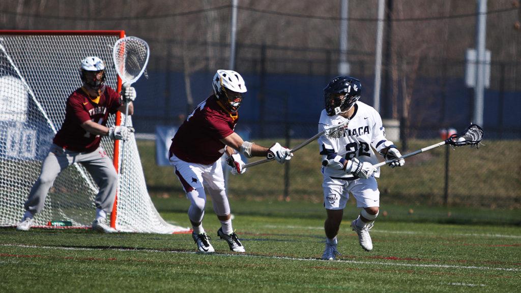 Senior attacker John Januszkiewicz looking to pass the ball to a teammate and score in the teams win April 12 against St. John Fisher College 19–10.