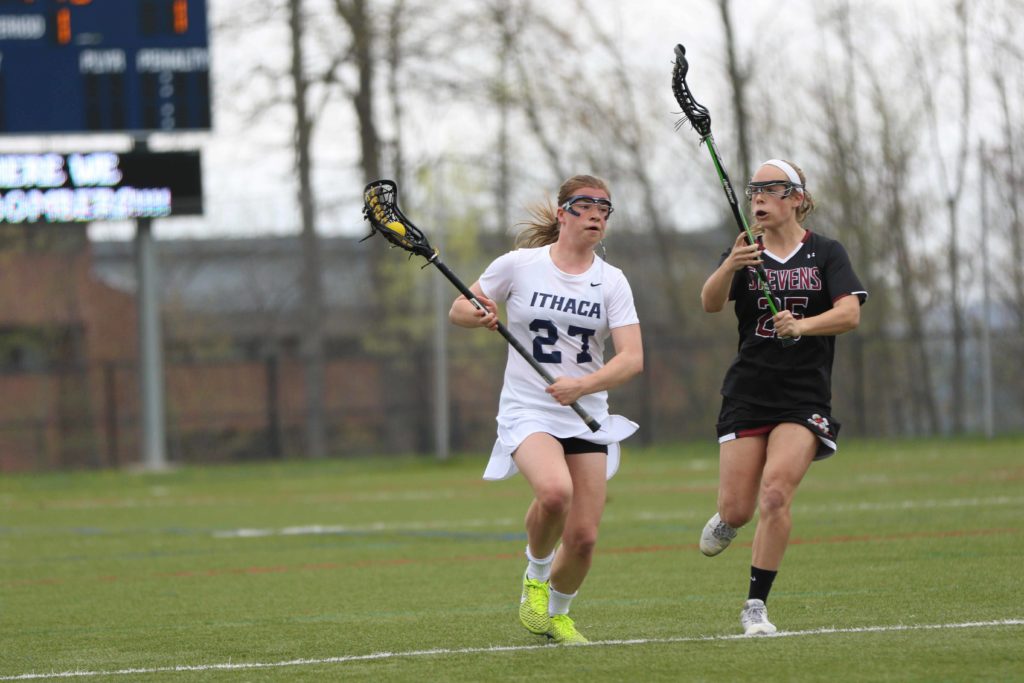 Freshman defender Becky Mehorter runs with the ball and looks to pass it to a teammate before freshman attack Kyra Bednarski of Stevens catches up to her. The Bombers defeated the Ducks 13–9.
