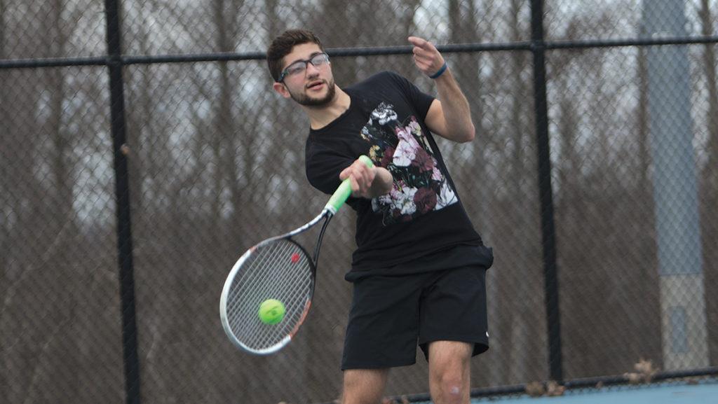 Senior tennis captain Brandon Buksbaum, whose father died two years ago, hits the ball during practice April 3 at the Ben Wheeler Tennis Courts. Buksbaum practiced drills against his teammates to help improve his hitting and serving. 