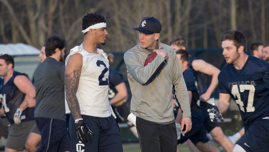 Freshman wide receiver Will Gladney talks with wide receivers coach Reece Petty between drills during football practice April 23 at Higgins Stadium. Petty was hired by head coach Dan Swanstrom on April 13.
