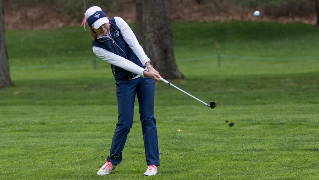 Junior Lauren Saylor hitting the ball on the green of the Country Club of Ithaca at the Ithaca College Invitational April 22–23. The Bombers placed second in the tournament behind Methodist College.