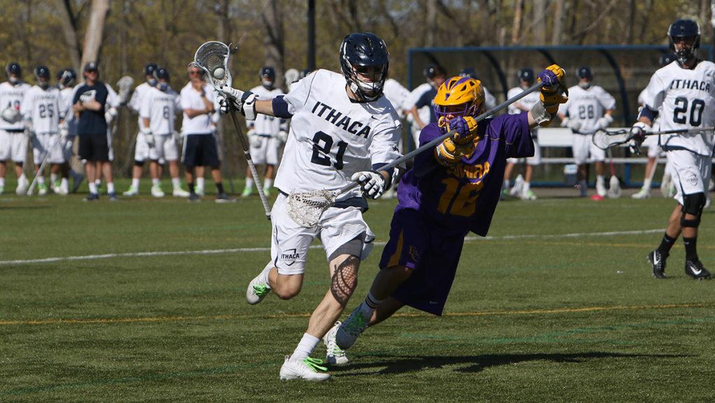 Sophomore midfielder Owen Smith running with the ball before Soaring Eagles freshman defender Adam Newhard tries to get the ball. The Bombers defeated Elmira College 19–4. 
