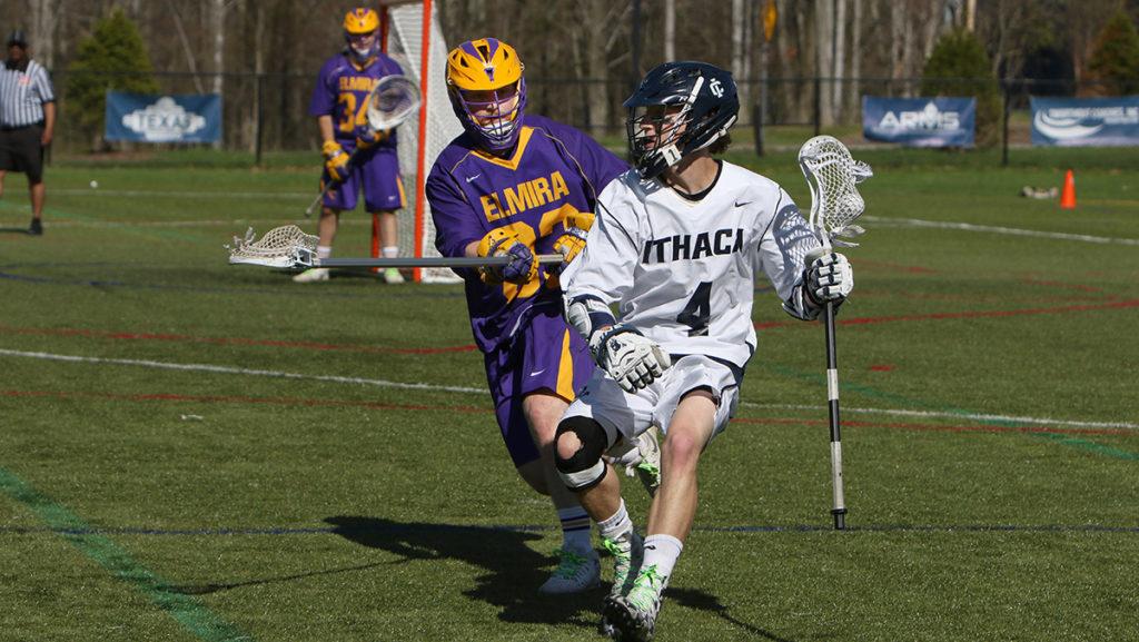 Sophomore attacker Will Witter with the ball and looking to pass the ball to a teammate before freshman defender Spencer Carter comes in to defend. The Bombers defeated Elmira College 19–4 April 26. 