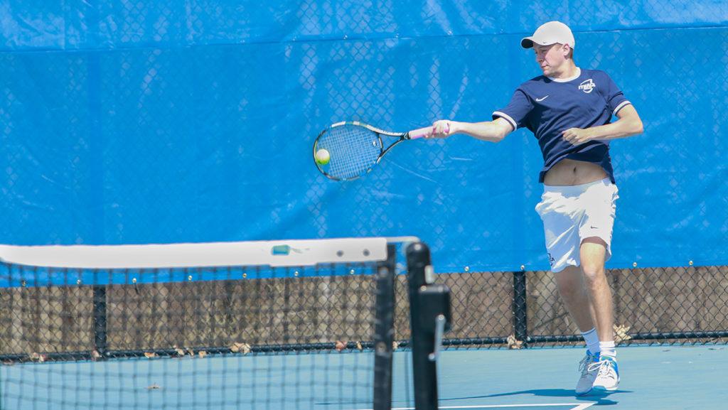 Freshman Colten Lavery hitting the ball back over the net during his doubles match with teammate, senior Nate Wolf. The pair won their match 8–0.