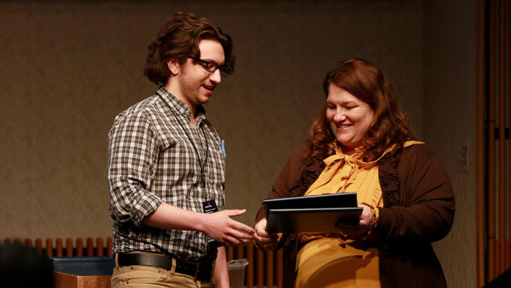 Junior Justin Henry receiving an award from Kimberly Wilkinson, assistant professor in the Department of Occupational Therapy, for his presentation on the corporatization of higher education with a focus on Ithaca College, entitled “‘Corporatizing’ College: The story of Ideological Divide at Ithaca College.”