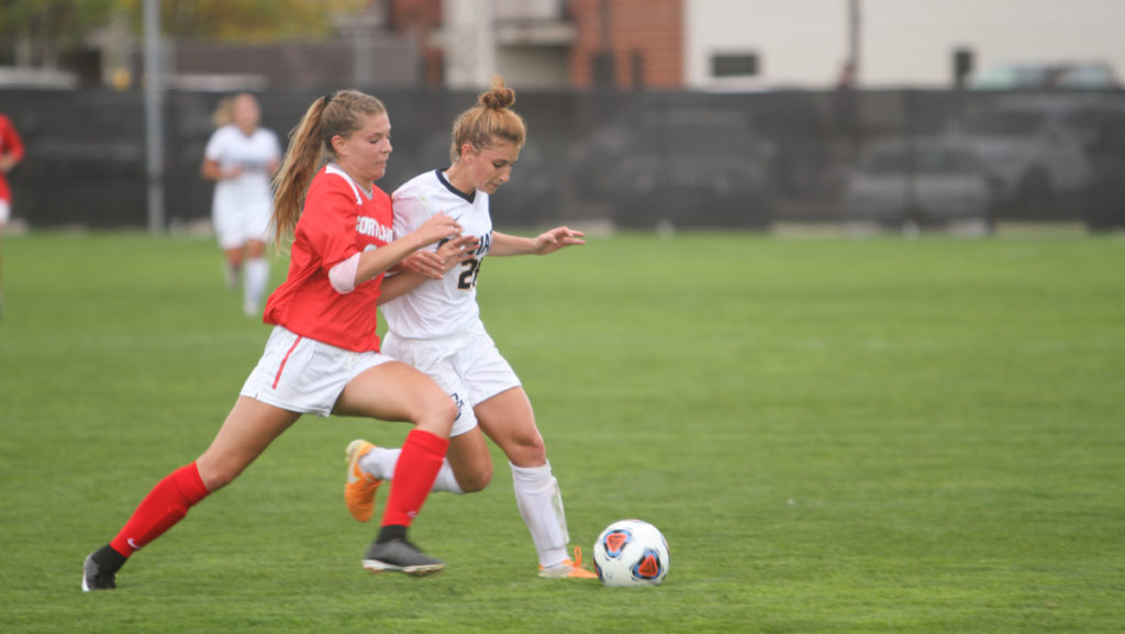 Junior midfielder Shoshana Bedrosian and freshman defender Kyleigh Gallagher of SUNY Cortland fight for the soccer ball in the Bombers loss to the Red Dragons 1–0.