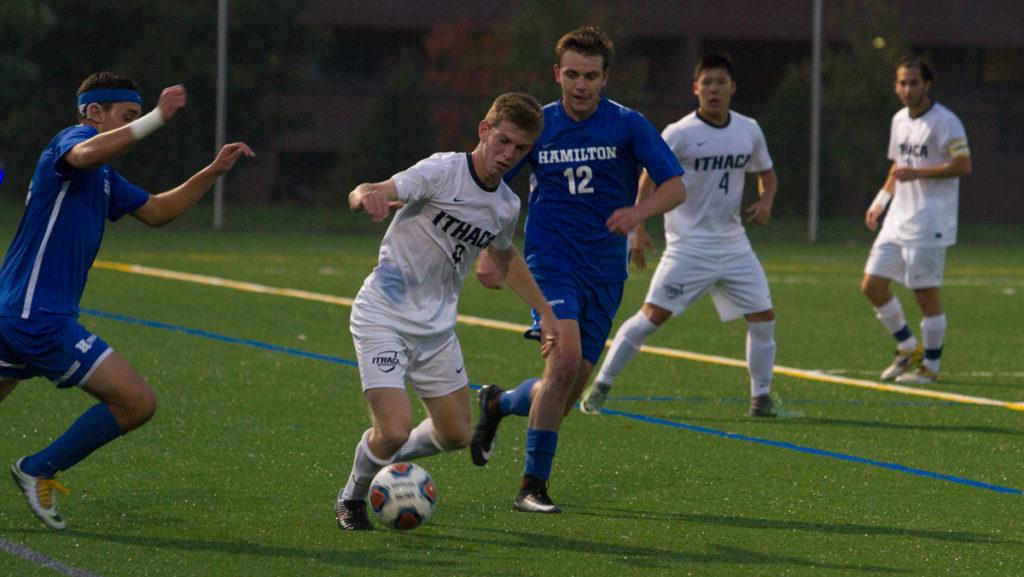 Sophomore forward Max Barish gets control of the ball as sophomore forward Aiden Wood of Hamilton College tries to come behind him and get the ball.