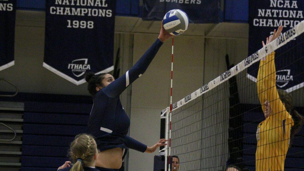Junior middle hitter Ruby Dyson hits the ball over the net during the Bombers home game against Alfred University Sept. 30. The Bombers won the game 3–0.