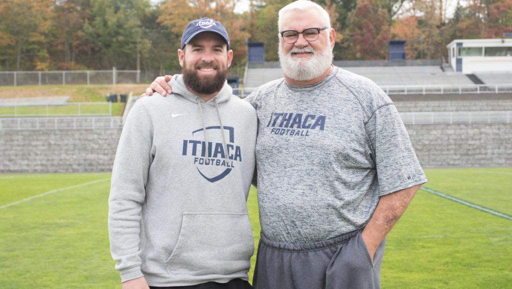 From left, linebackers coach Brody Trahan and his father, defensive line coach Warren “Bull” Trahan, coach together for the Ithaca College football team. Warren brings 35 years of coaching experience to the Bombers. 