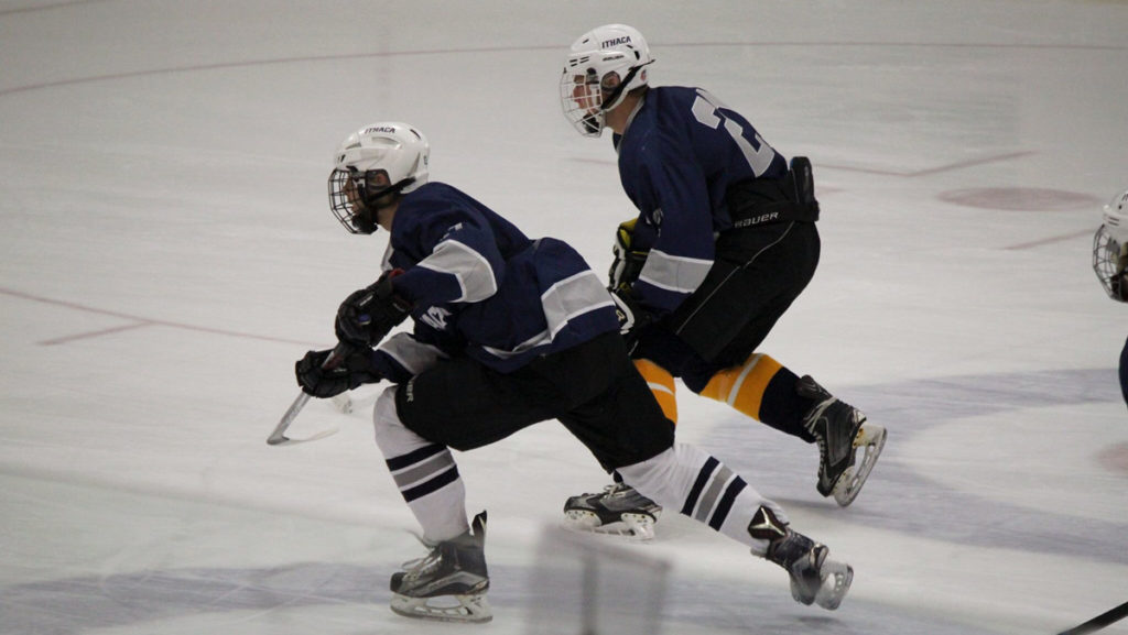 From left, sophomore forward Austin Morley and junior defender Andy Rossler skate down the ice during their game against SUNY Cortland Oct. 1. The Blue and Gold lost 7–4 and have a 1–2 record.