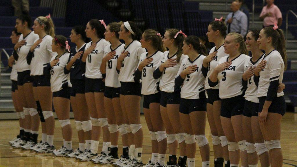 Members of the womens volleyball team stand for the national anthem before their game, a practice that junior Jack Morello says helps Americans understand their country.