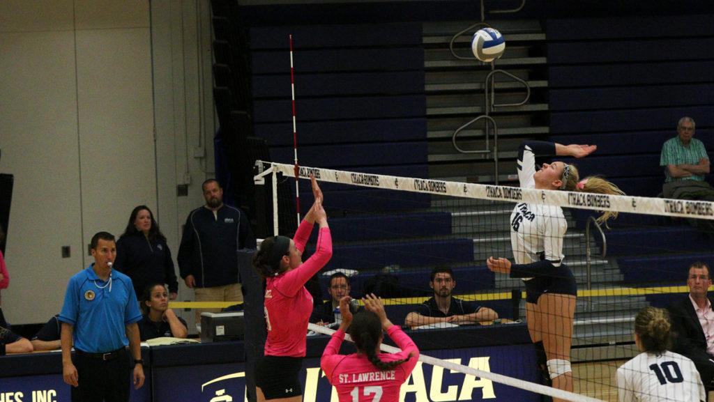From left, Grace Kelly, junior outside hitter for St. Lawrence, prepares to receive the spike from Reagan Stone, Ithaca College freshman middle hitter. The Bombers defeated the Saints. 3–0 Oct. 6 at Ben Light Gymnasium.