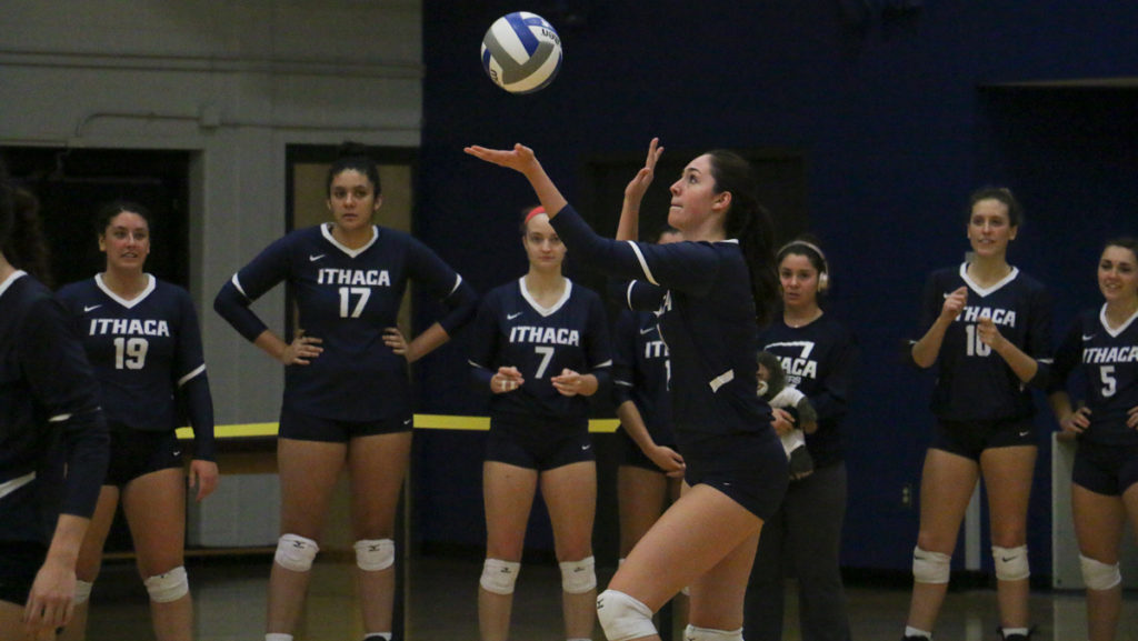 Freshman outside and middle hitter Katie Casey sets the ball up to serve during the Bombers game against SUNY Cortland Oct. 11. The Blue and Gold defeated the Red Dragons 3–0.