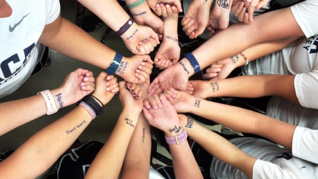 Prior to a game, members of the field hockey team wrote “hard work” on their wrists because head coach Kaitlyn Wahila pushes them to work as hard as they can. Prior to all games, the team writes a different phrase. 