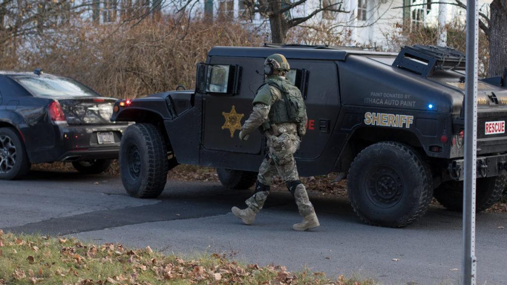 A+SWAT+team+member+walks+back+to+his+vehicle+after+responding+to+a+situation+where+a+man+barricaded+himself+in+a+house+on+Hudson+Street.+