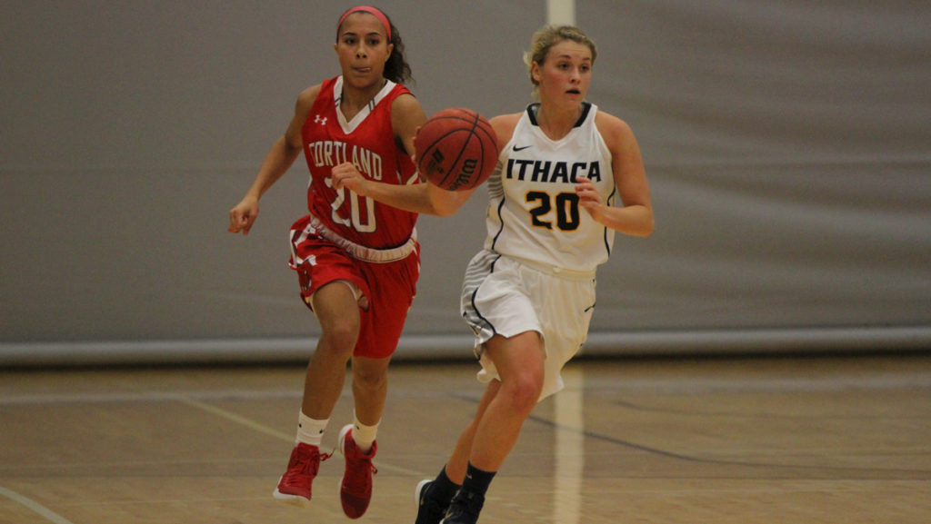 Senior guard Erin Woop dribbles down the court with junior forward Justine Crespo of the Red Dragons trying to catch up to her. The Bombers defeated the Red Dragons 78–58.