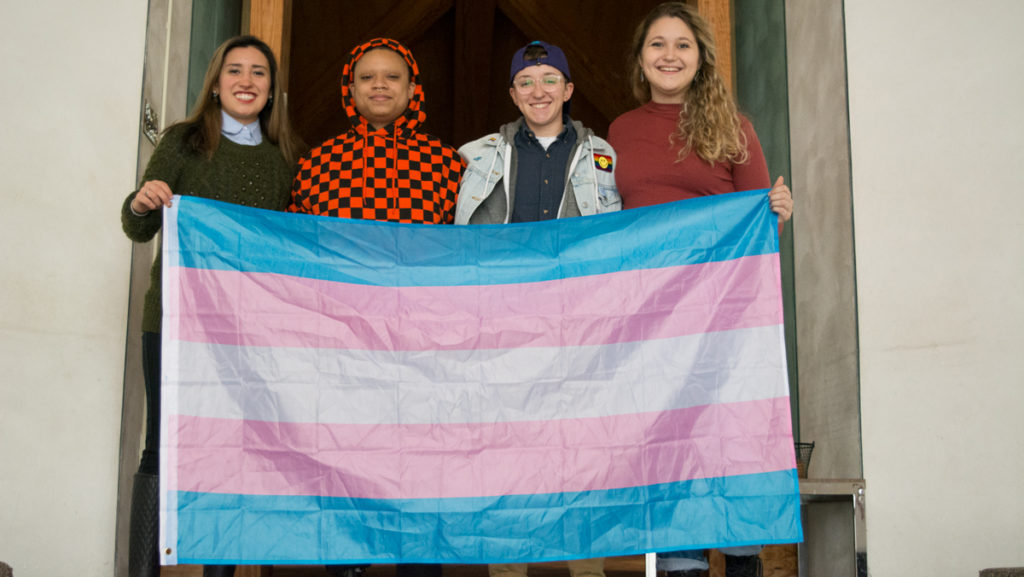 From left, junior Elena Piech, seniors X Rance and Jay Williamson and junior Rosemary Mulvey hold a transgender pride flag.
