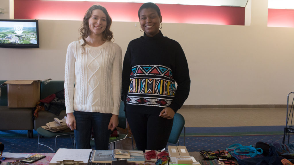 Junior Rachel Hamlin, president of IC Circle K, and Senior Stephanie Greenidge, the vice president of IC Circle K, stand at the sixth annual holiday fundraiser sale. The holiday sale is a collaboration between IC Circle K and local fair-trade store One World Market. 