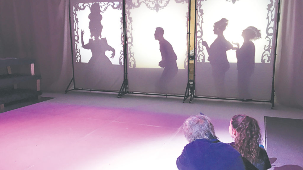 Sophomore Lucia Vecchio, who plays the role of Greta in “The Snow Queen,” and Jeffrey Guyton, cast member, watch a shadow puppetry scene during a rehearsal at The Cherry Arts.