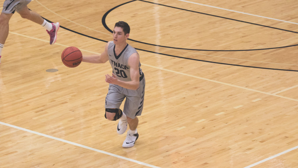 Freshman guard Cooper Macklin brings the ball up during the Bombers’ 100–72 victory over SUNY Canton on Nov. 17 at Ben Light Gymnasium. Macklin is averaging five points per game.