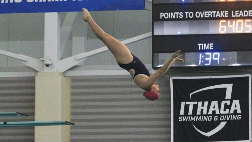 Freshman diver Jocelyn Pawcio flips off the diving board at the Ithaca Bomber Invitational. Pawcio compeed in gymnastics for her entire life before switching to diving at the start of this season.