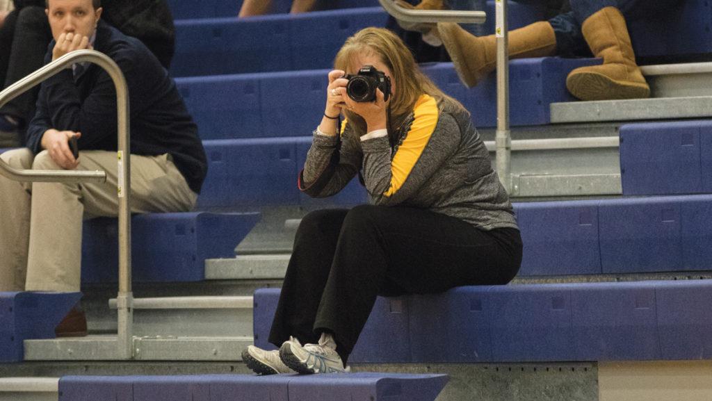 Sue Jackson, mother of junior guard Sara Jackson, takes pictures at all of the Bombers games. 