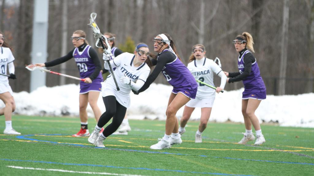 Junior attacker Allie Panara goes up against Kyra Kempney, junior defender from Nazareth College, during the Bombers 14–8 win Feb. 24.