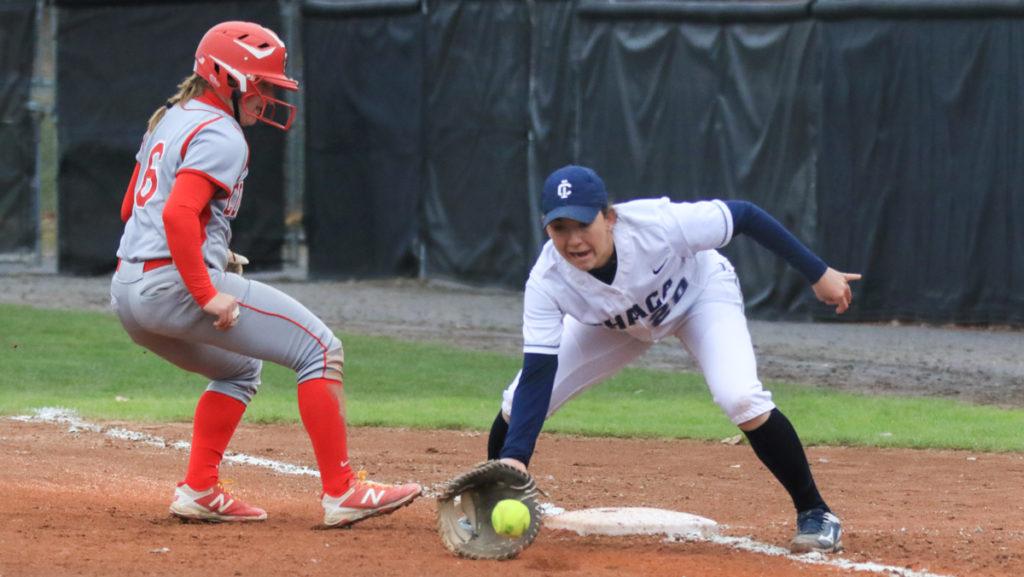 Junior infielder Alex Wright attempts to get Ericka Sadowski, SUNY Cortland sophomore utility player, out at first base during the Bombers 8–1 win April 18.