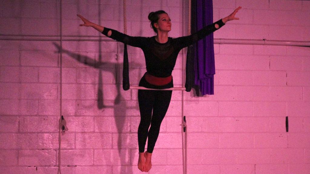 Senior and club co-president Emily Brumfield balances on a hanging trapeze durng her act at ICircus’s Planet Earth showcase. To match the showcase’s Planet Earth theme, the title of each act included an animal or element of nature.