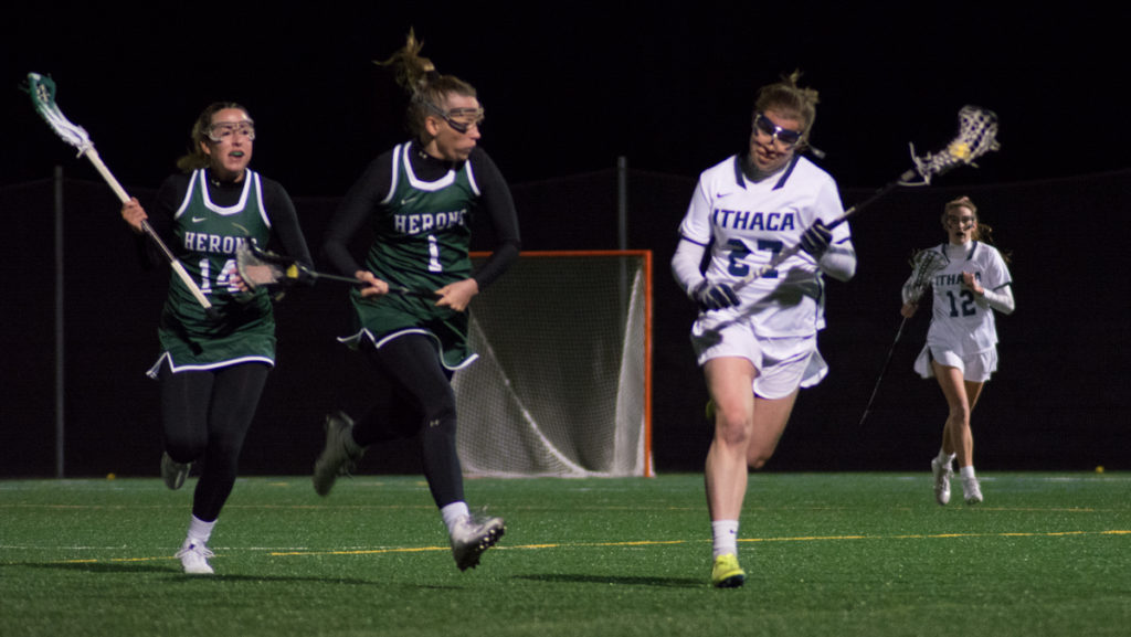 Sophomore defender Becky Mehorter runs down the field against William Smith College senior midfielder Ali Burns and freshman midfielder Anna Murphy during the Bombers loss April 13.