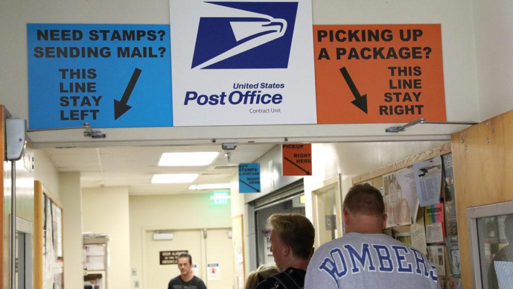 Ithaca College residents line up at Phillips Hall Post Office in Campus Center to pick up their mail. Now, residents are able to get both letters and packages at the same location. 