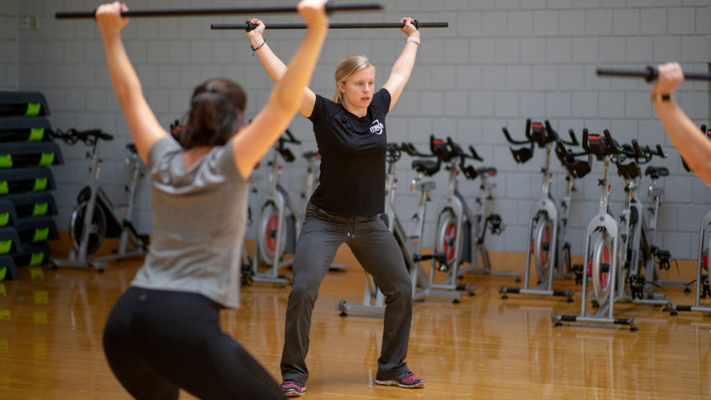 Senior Sydney Malaspina teaches a BODYPUMP class in the Ithaca College Fitness Center aerobics room. Malaspina is one of the many students that lead their own group fitness classes every week.