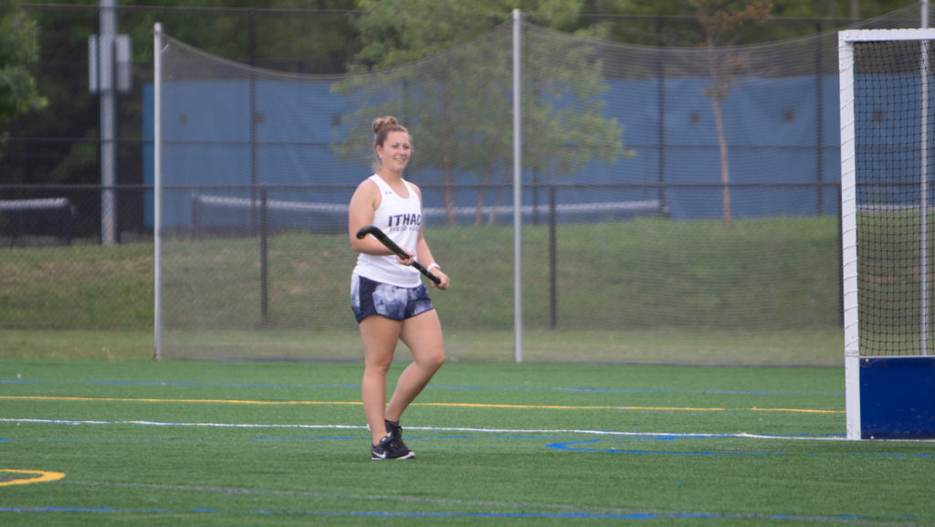 Assistant+field+hockey+coach+Caitlin+OBrien+16+demonstrates+during+practice.+The+Alumna+is+now+in+her+third+position+with+the+team%2C+going+from+player+to+trainer+to+coach.