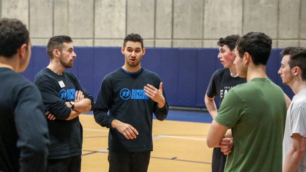 From left, graduate students Robert Allen and Andrew Ward conduct a workshop for the Ithaca College mens club volleyball team Nov. 27.